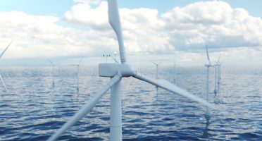 Wind farm turbines in sea. Beautiful contrast with the blue sea. Ecological net energy, clean energy, wind energy Offshore wind turbine farm in the sea or ocean