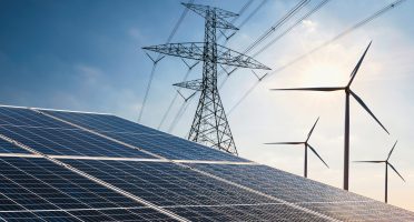 electricity power in nature. clean energy concept. solar panel with turbine and tower hight voltage