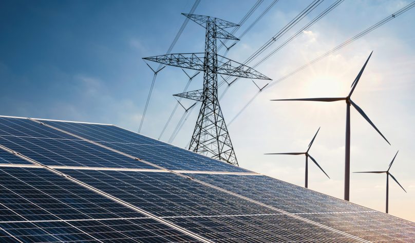 electricity power in nature. clean energy concept. solar panel with turbine and tower hight voltage