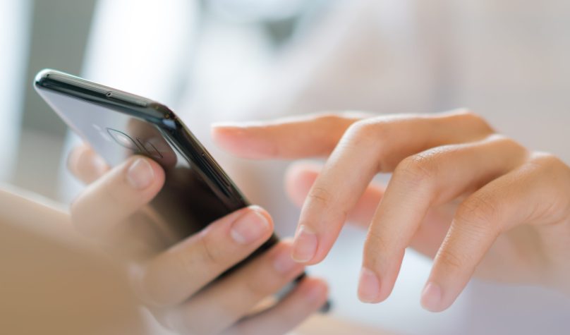 Business hand with mobile phone